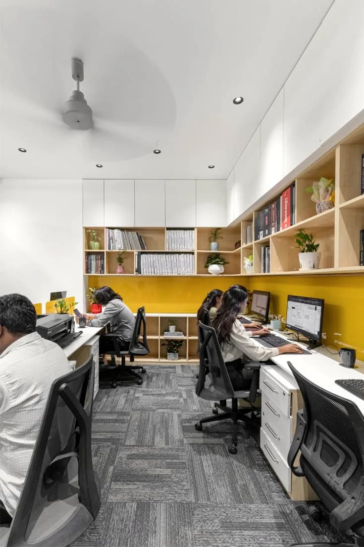 A small room with open shelving and a ceiling fan.