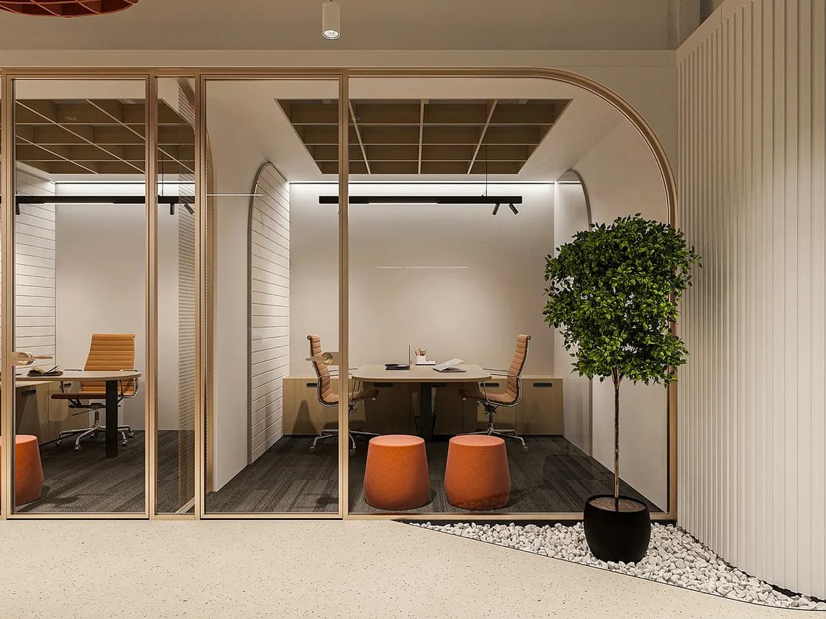 A glazed meeting room behind an arched frame, a tree beside it.